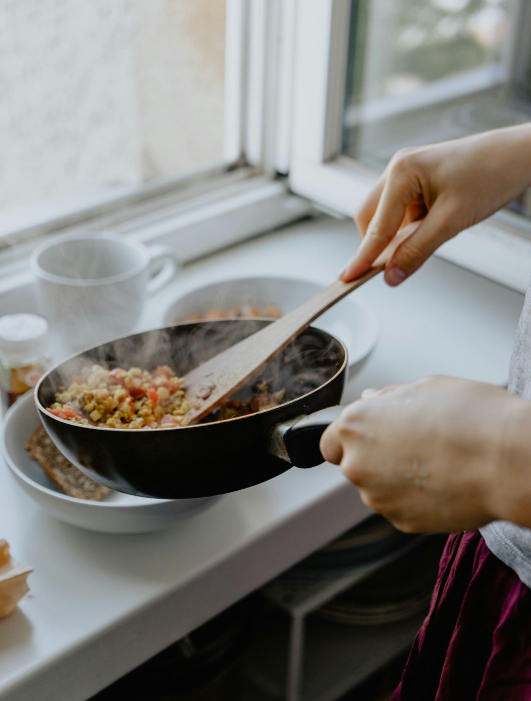 A pan of vegetables steaming on the stove